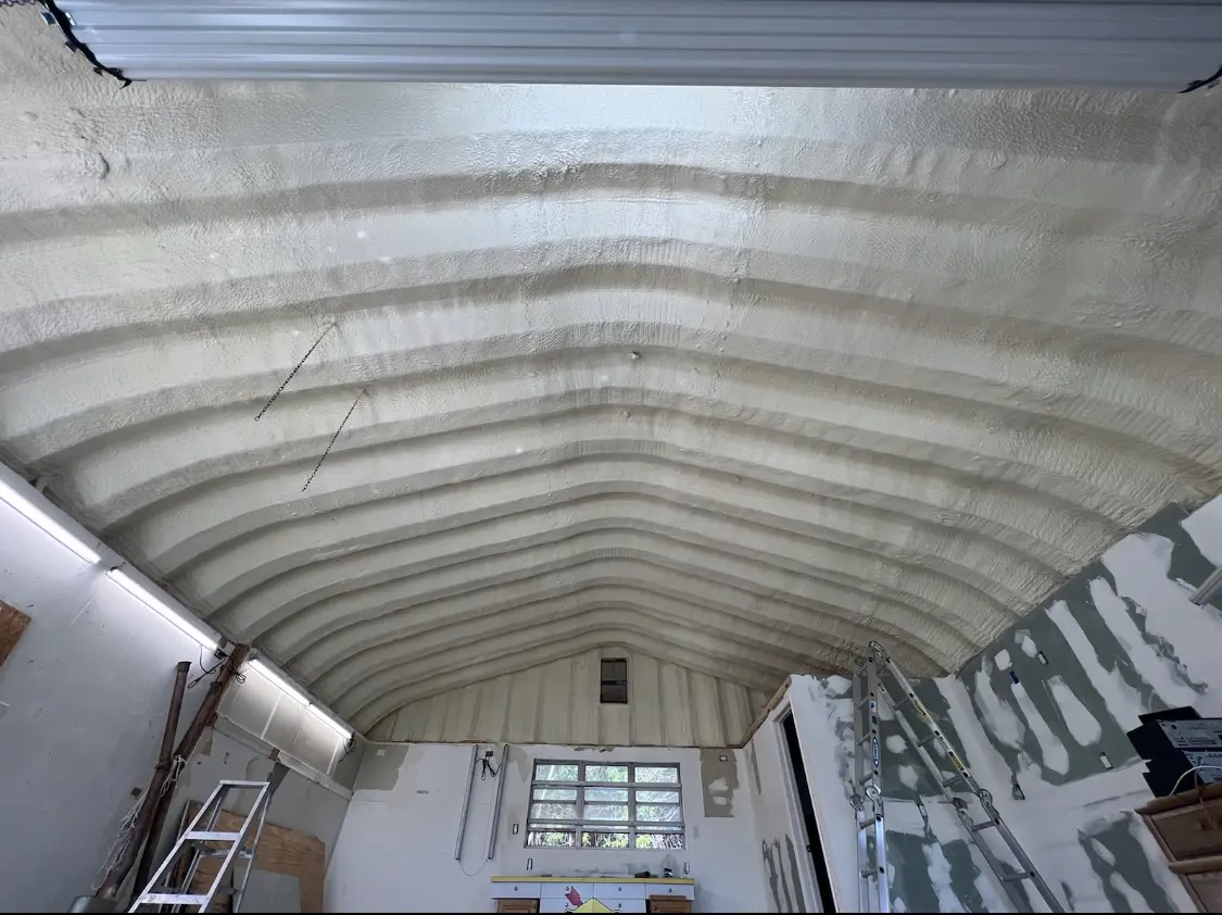 Spray polyurethane foam applied to the underside of a metal roof deck in Bern